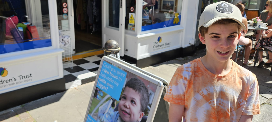 Samuel volunteering at The Children's Trust charity shop