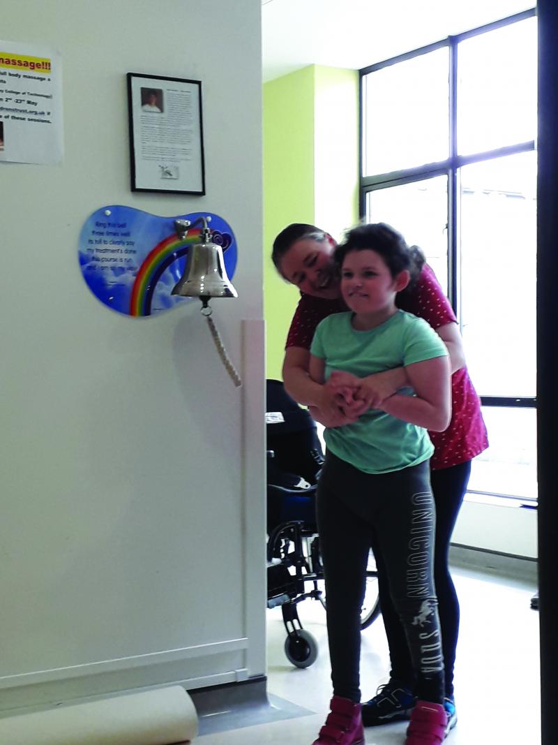 Chloe ringing the going home bell