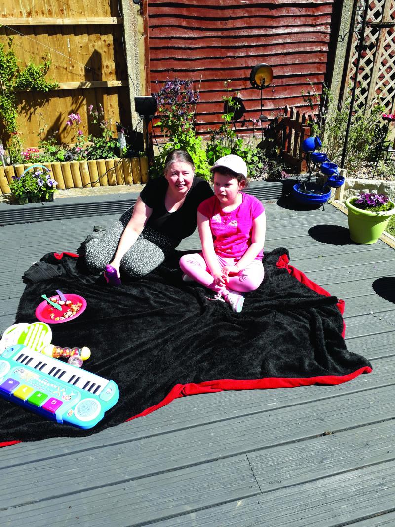 Chloe sat outside with mum Sara