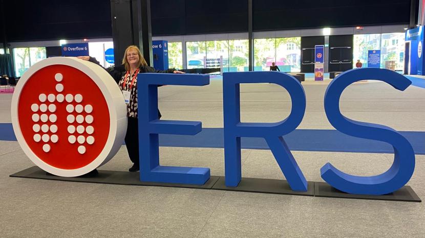 Heather stands behind ERS sign